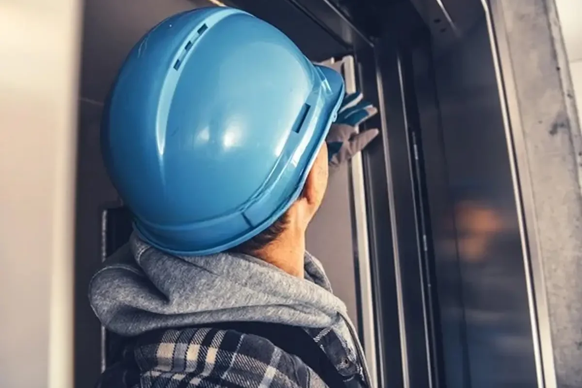 caucasian-elevator-technician-wearing-blue-600w-2119748726 2
